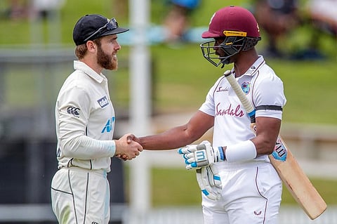West Indies batsman Kemar Roach (R) congratulates New Zealand's captain Kane Williamson for victory in the first Test cricket match. (Photo | AFP)