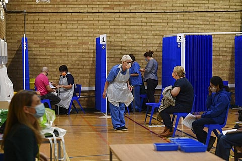 Medical staff in booths prepare to administer the Pfizer-BioNTech COVID-19 vaccine at a vaccination centre in Cardiff. (Photo | AP)