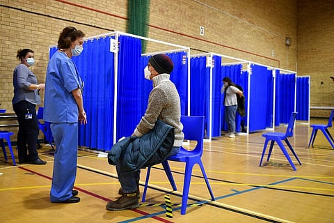 Medical staff in booths prepare to administer the Pfizer-BioNTech COVID-19 vaccine at a vaccination centre in Cardiff. (Photo | AP)