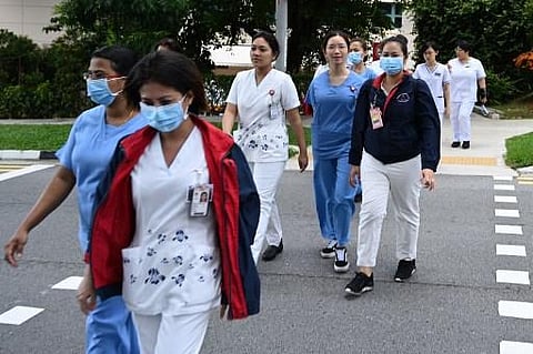 Medical staff walk to the National Centre for Infectious Diseases building at Tan Tock Seng Hospital in Singapore on January 31, 2020. (Photo | AFP)