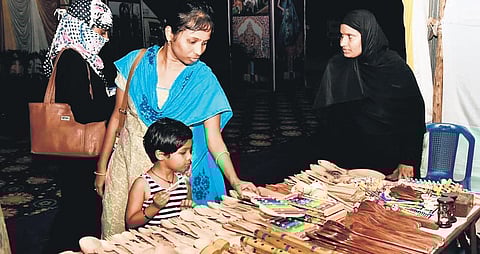 Customers browsing goods at a stall in Lepakshi Expo-2020, underway at Swaraj Maidan in Vijayawada on Friday. (Photo | EPS)