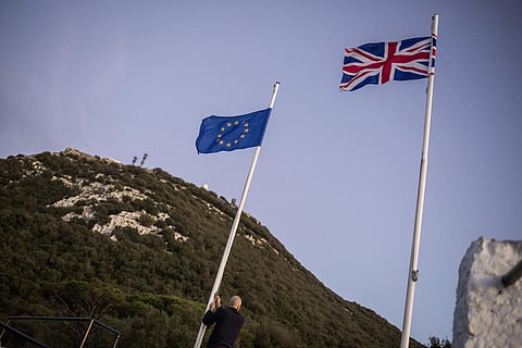 worker lowers the EU flag at the British territory of Gibraltar, Friday Jan. 31, 2020. (Photo | AP)