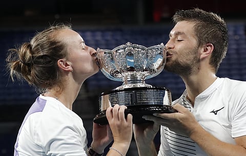 Barbora Krejcikova of the Czech Republic (L) & Croatia's Nikola Mektic kiss their trophy after winning the Australian Open mixed doubles final in Melbourne. (Photo | AP)