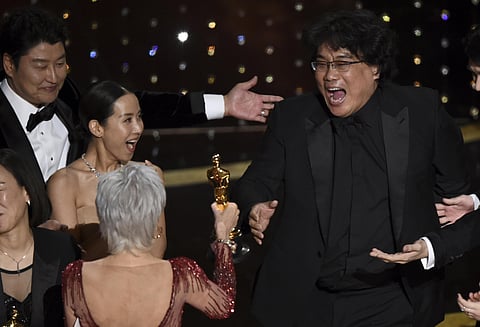 Bong Joon Ho, right, reacts as he is presented with the award for best picture for 'Parasite' from presenter Jane Fonda at the Oscars on Sunday, Feb. 9, 2020, at the Dolby Theatre in Los Angeles. Looking on from left are Kang-Ho Song and Kwak Sin Ae. The 