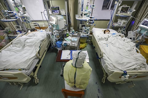 A medical worker monitors patients in the isolated intensive care unit at a hospital in Wuhan in central China's Hubei province. (Photo | AP)