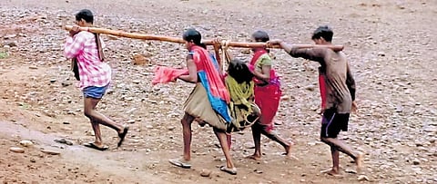 Maina Bisoi went into labour following which her family members carried her to Dasmanthpur PHC on their shoulders by crossing Pada river.