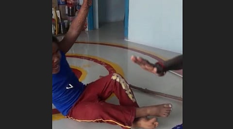 A screenshot from the video which shows Sharanamma roughing up the toddler.