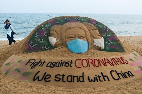 A sand sculpture expressing solidarity with China made by Sudarsan Pattnaik at Puri beach. (Photo| AFP)