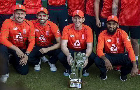 England's captain Eoin Morgan, second from right, with teammates pose for photographers after winning the T20 cricket series against South Africa at Centurion Park in Pretoria, South Africa, Sunday, Feb. 16, 2020. (Photo | AP)