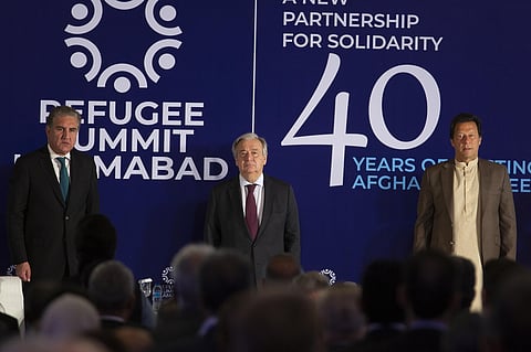 U.N. Secretary-General Antonio Guterres, center, listens to national anthem with Pakistani Foreign Minister Shah Mahmood Qureshi and Pakistani Prime Minister Imran Khan, right, during the Refugee Summit in Islamabad, Pakistan, Monday, Feb. 17, 2020. (Phot