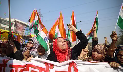 Women wave tricolours during their ongoing protest against CAA and NRC at Shaheen Bagh in New Delhi Sunday Feb. 16 2020. (Photo | EPS)