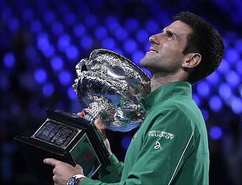 Serbia's Novak Djokovic holds the trophy after defeating Austria's Dominic Thiem in the Australian Open final. (Photo | AP)