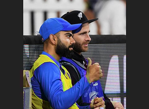 Captains Virat Kohli and Kane Williamson watch the game from the sideline during the final T20 match between India and New Zealand at Bay Oval. (Photo | AP)