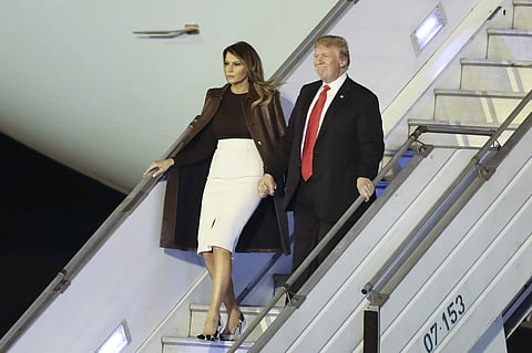 President Donald Trump and first lady Melania Trump walk from Air Force One. (Photo | AP)