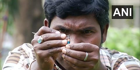 L Eswar Rao, an artist from Bhubaneswar's Jatni, has made a miniature model of a 'Shivling', on a pencil nib. (Photo | ANI)