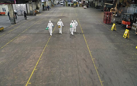 Workers wearing protective gears spray disinfectant as a precaution against the new coronavirus at Agricultural and Wholesale Products Center in Daegu, South Korea, Thursday, Feb. 20, 2020. (Photo | AP)
