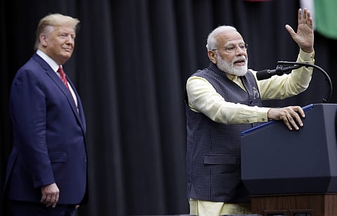 President Donald Trump listens as India Prime Minister Narendra Modi introduces him during the 'Howdy Modi' event. (File Photo | AP)