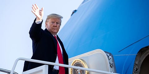 US President Donald Trump waves as he boards Air Force One to depart for India. (Photo | AP)