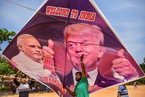 Youngster fly a kite with portraits of Prime Minister Narendra Modi and US President Donald Trump ahead of Trump's maiden visit to India in Bengaluru Sunday. (Photo | PTI)