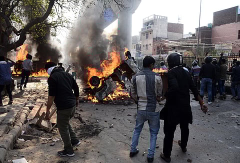 Protesters hurl brick-bats during clashes between a group of anti and pro CAA supporters at Jafrabad in north-east Delhi on Monday. (Photo | Parveen Negi/EPS)
