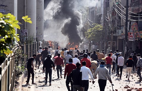 Protesters during clashes between a group of anti and pro CAA supporters at Jafrabad in north-east Delhi on Monday. (Photo | Parveen Negi/EPS)
