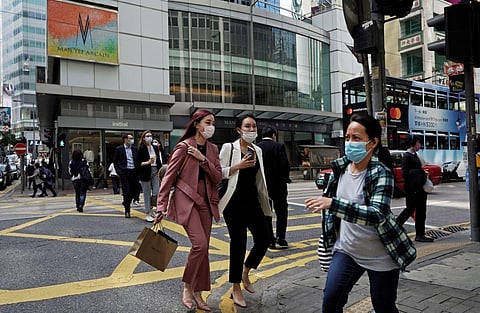 People wearing masks, walk across a street in Hong Kong, Monday, Feb. 24, 2020. The COVID-19 viral illness has sickened thousands of people throughout China and other countries since December. (Photo | AP)