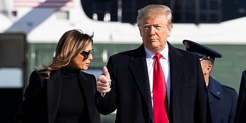 US president Donald Trump, with first lady Melania Trump, gives a thumbs up as they walk to board Air Force One to depart for India. (Photo| AP)