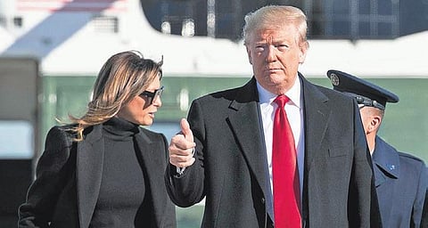 US President Donald Trump, with first lady Melania Trump, gives a thumbs up before boarding Air Force One to depart for India on Sunday at Andrews Air Force Base | ap