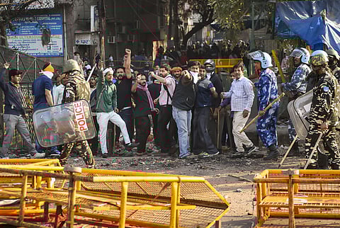 Security personnel stand guard during clashes between those supporting and against the Citizenship Amendment Act in north east Delhi Tuesday Feb. 25 2020. (Photo | PTI)