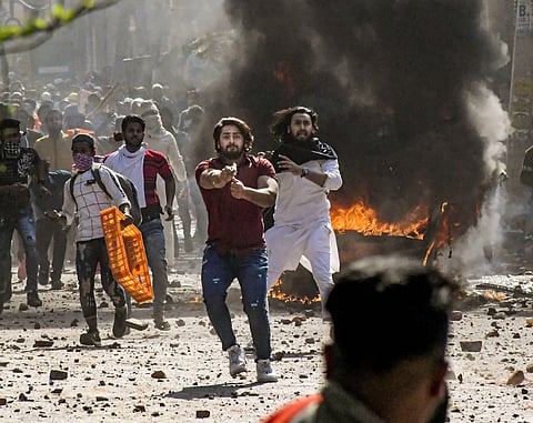 A protestor brandishes a pistol during clashes between a group of anti-CAA protestors and supporters of the new citizenship act, at Jafrabad in north-east Delhi, Monday, Feb. 24, 2020. (Photo | PTI)