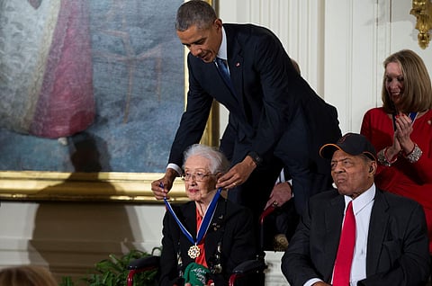 In this Nov. 24, 2015 photo, Willie Mays, right, looks on as President Barack Obama presents the Presidential Medal of Freedom to NASA mathematician Katherine Johnson during a ceremony in the East Room of the White House, in Washington. Johnson, a mathema