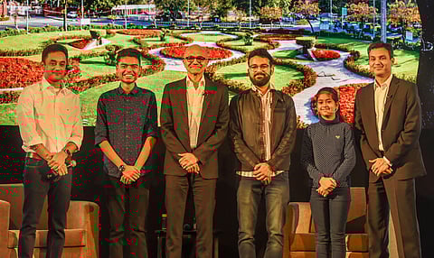 Satya Nadella (3rd left) poses for a group photo with Namya Joshi (5th left) and other students during the Young Innovators Summit in New Delhi. (Photo | PTI)