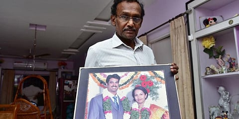 Gautam Buddha, father of Divya Avula showing a picture of his deceased daughter and son-in-law at his residence in Hyderabad on Tuesday. (Photo| EPS)