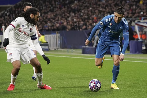 Juventus' Cristiano Ronaldo, right, and Lyon's Jason Denayer, left, vie for the ball during a round of sixteen, first leg, soccer match between Lyon and Juventus at the at the Lyon Olympic Stadium in Decines, outside Lyon, France, Wednesday, Feb. 26, 2020