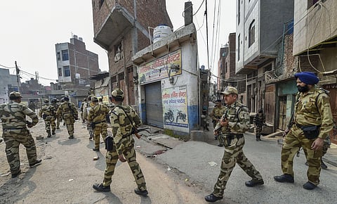 Security personnel patrol streets following clashes over the new citizenship law, in Bhagirathi area of northeast Delhi. (Photo | PTI)