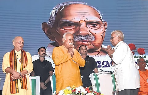Scholar V R Prabodhachandran Nair greets RSS chief Mohan Bhagwat at ‘Namami Parameswaram’, held in memory of RSS ideologue P Parameswaran, in Thiruvananthapuram on Wednesday. Spiritual leader Sri M is also seen I B P Deepu