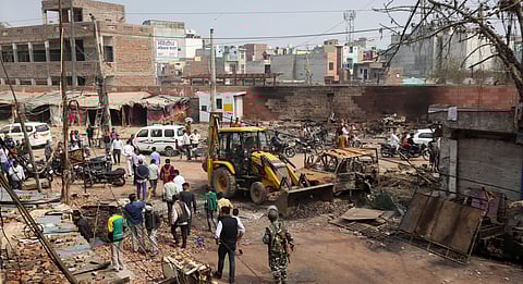 Workers remove debris in a riot-affected area following clashes between people demonstrating for and against a new citizenship law in New Delhi on Friday. (Photo | Shekhar Yadav/EPS)