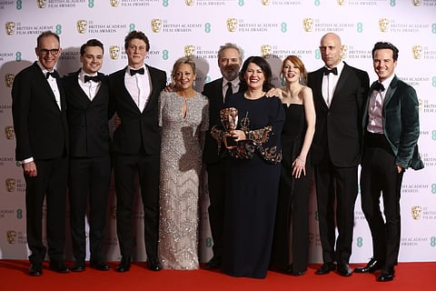 From left, Callum McDougall, Charles Chapman, George Mackay, Jayne-Ann Tenggren, Sam Mendes, Pippa Harris, Krysty Wilson-Cairns, Mark Strong and Andrew Scott, winners of Best Film for 1917, backstage at the Bafta Film Awards, in central London, Sunday, Fe