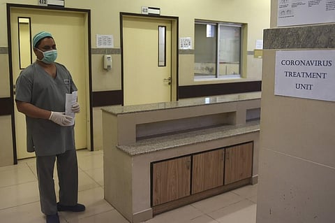 A medical staff member wearing protective facemask walks in an isolation ward set up at the Jinnah Post Graduate Medical Center (JPMC) in Karachi on February 3, 2020. (Photo | AFP)