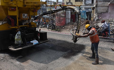 VMC has started using emulsion-based cold mix instead of hot bitumen mixes for fixing the damaged and pothole ridden Jawharlal Nehru Road. (Photo | P Ravindra Babu, EPS)