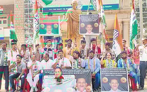 Congress workers stage a protest at Congress Bhavan in Bengaluru on Monday against BJP MP Anant Kumar Hegde for his remarks on the freedom struggle