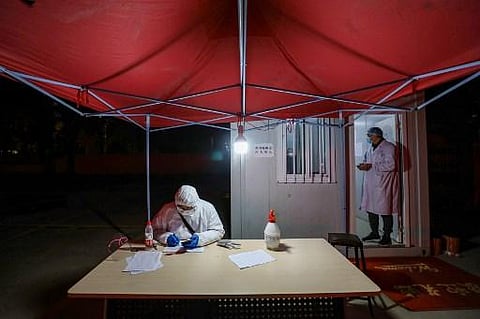 Medical staff members working at a quarantine zone in Wuhan, the epicentre of the new coronavirus outbreak, in China's central Hubei province. (Photo | AFP)