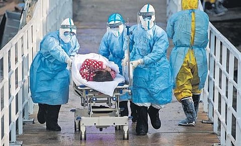 The first group of patients being taken to the Huoshenshan temporary field hospital in China’s Wuhan on Tuesday | AP