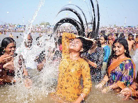 Scores of devotees take a dip in the Jampanna Vagu at Medaram village in Mulugu district on Thursday  on the second day of the Sammakka Saralamma Jatara. (Photo| Vinay Madapu, EPS)