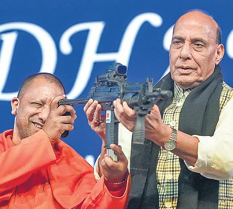 The vehicle known as Unexploded Ordnance Robot (UXOR) is part of the display at the DefExpo 2020 in Lucknow. (R) UP CM Yogi Adityanath checks a gun held by Defence Minister Rajnath Singh at DefExpo in Lucknow | Mayank Singh & PTI
