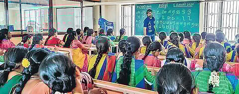 Ramasubramaniam teaching the Tamizhi script to the  students and teachers at a special workshop;