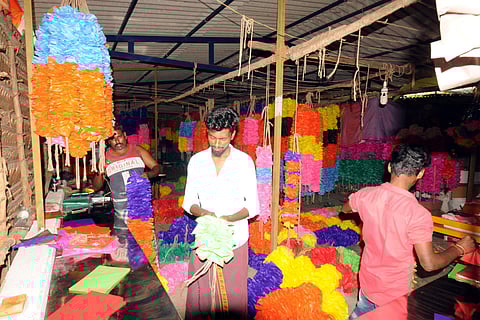 Hundreds of people are involved in the garland-making process in the town near Kulamangalam.