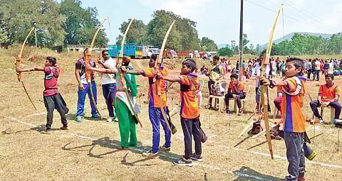 Girls and boys take part in archery competition as part of Araku Utsav at Araku in Vizag district on Saturday I Express