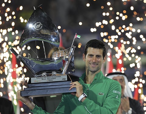 Novak Djokovic holds the trophy after he beats Stefanos Tsitsipas of Greece in the final match of the Dubai Duty Free Tennis Championship. (Photo | AP)