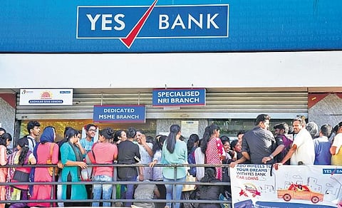 People queue up in front of Yes Bank in Mangaluru on Saturday. (File photo| Rajesh Shetty, EPS)